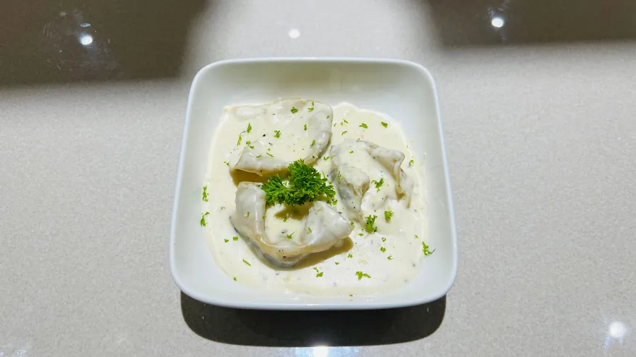 Corn and bell pepper ravioli in a velvety cream sauce