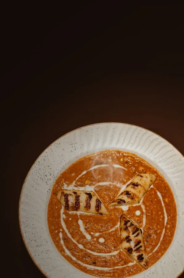Grill-marked paneer resting in a slow-cooked royal gravy with cream